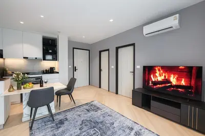 a living room with a fireplace and a dining room at The Title Legendary Bang Tao - Modern 1BR Resort Apartment in Bang Tao Beach