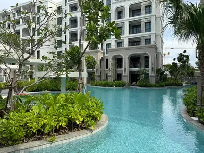 a swimming pool in front of a building at The Title Legendary Bang Tao - Modern 1BR Resort Apartment in Bang Tao Beach