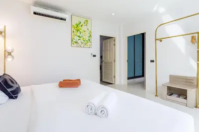 a white bathroom with a sink and a mirror at New! bayfront 2 BR Villa with private pool Nariya V1 - rare find in Phuket in Chalong