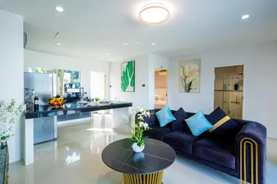 a living room with a couch and a table at Exclusive! 3-Bedroom Pool Villa with Bay View-Nariya V8 in Chalong