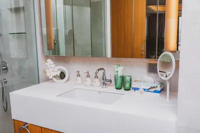 a bathroom with a white sink and a mirror at Luxury Angsana Residence in Bang Tao Beach