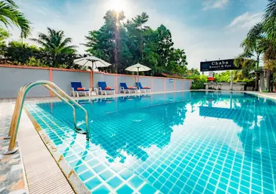 a pool at a hotel with chairs and umbrellas at Chabana Resort Bang-tao Beach Phuket- SHA Extra Plus in Bang Tao Beach
