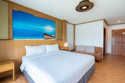 a bedroom with a large bed and a window at Chabana Resort Bang-tao Beach Phuket- SHA Extra Plus in Bang Tao Beach