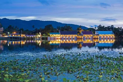 a building on the water with lights on it at Chabana Resort Bang-tao Beach Phuket- SHA Extra Plus in Bang Tao Beach