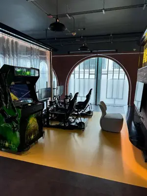 a room with a video game console and a chair at Апартаменты у океана пляж Бангтао Title Legendary Bangtao in Bang Tao Beach