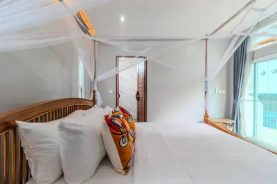 a bedroom with a canopy bed with white pillows at V256 Huge Modern 10BR ZipLine 3 Pools Fully Loaded in Rawai Beach