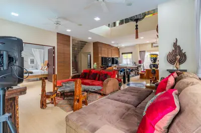 a living room with a couch and a table at V256 Huge Modern 10BR ZipLine 3 Pools Fully Loaded in Rawai Beach