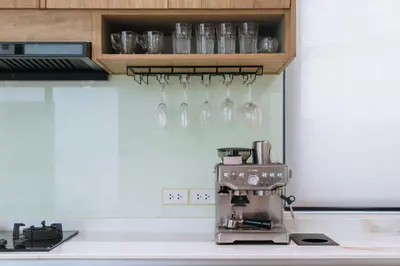 a kitchen counter with a coffee maker and glasses at V257 Spacious 5BR Villa Waterfall Pool Movie Room in Rawai Beach