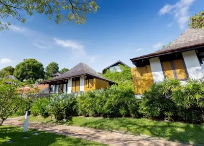 a resort with yellow and white buildings and trees at The Vijitt - Deluxe Villa in Ban Saiyuan (1)