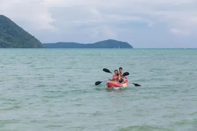 two people riding on a kayak in the water at The Vijitt - Deluxe Villa in Ban Saiyuan (1)