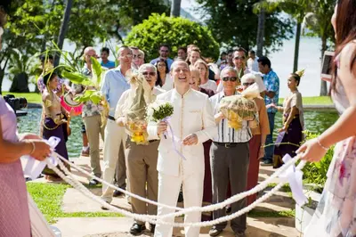 a bride and groom are cutting the ribbon at The Vijitt Resort - Vijitt Pool Villa in Ban Saiyuan (1)