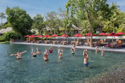 a group of people doing yoga in the water at a resort at The Vijitt - Two Bedroom Pool Villa in Ban Saiyuan (1)