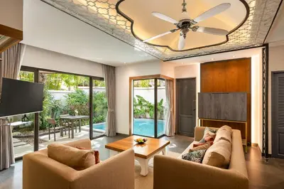 a living room with a couch and a ceiling fan at Dewa Villa in Nai Yang Beach