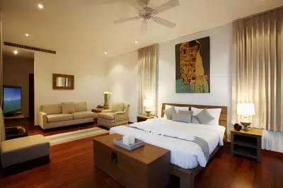 a bedroom with a large bed and a living room at Sea View Pool Villa Grand Kamala Falls in Kamala Beach