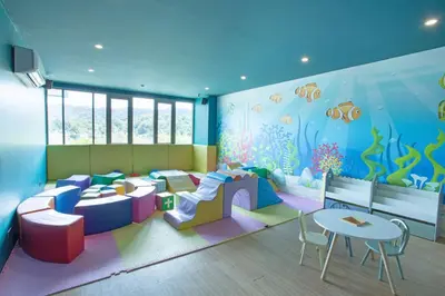 a room with a childrens room with an aquarium at Elegant 2BR Oceanview Condo Oceana C73 - 5 min walk Kamala Beach in Kamala Beach