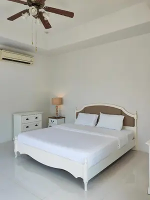 a bedroom with a white bed with a ceiling fan at Private Tropical Villa 2bdr Bangtao beach in Laguna Phuket
