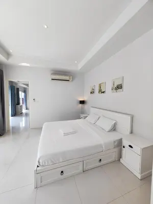 a white bedroom with a large bed with white walls at Private Tropical Villa 2bdr Bangtao beach in Laguna Phuket