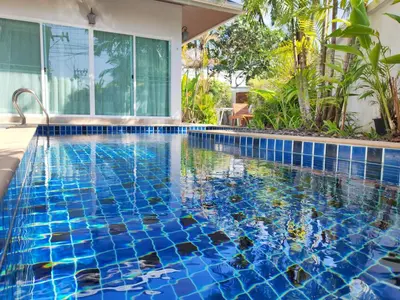 a swimming pool with blue tiles in a house at Private Tropical Villa 2bdr Bangtao beach in Laguna Phuket