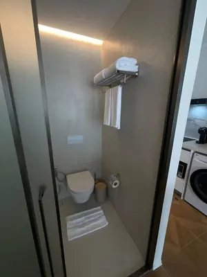 a small bathroom with a toilet and a sink at Kora Beach Studio in Layan Beach