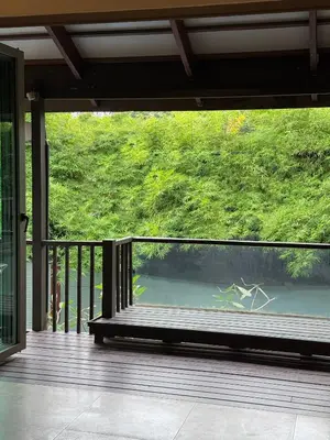 a balcony with a view of a body of water at Bukitier Luxury Pool Villa Bangtao in Bang Tao Beach