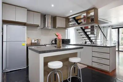 a kitchen with a counter and stools in it at 5 BR Villa Kalim 5 Private Pool with Seaview in Patong Beach