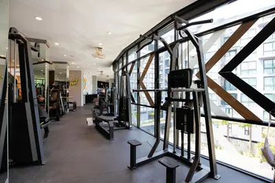 a gym with several tread machines and windows at Tropics Kamala CTG P615 - Corner 1 BR Apt Mountain view in Kamala Beach