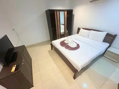 a bedroom with a bed and a flat screen tv at P&I Group Karon Beach Room-1 in Karon Beach