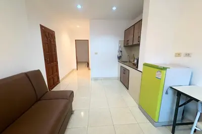 a living room with a couch and a kitchen at P&I Group Karon Beach Room-1 in Karon Beach