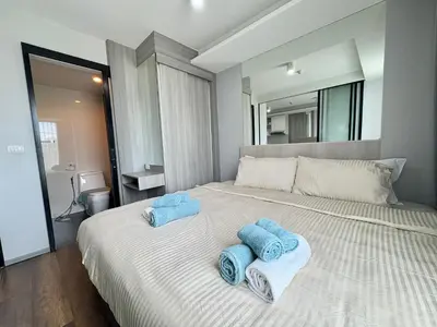 a bedroom with a bed with towels on it at 1 Bedroom l 6th Avenue l Surin beach in Surin Beach