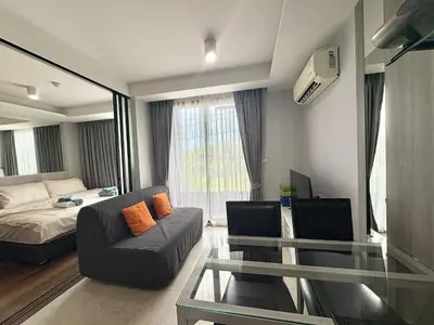 a living room with a bed and a glass table at 1 Bedroom l 6th Avenue l Surin beach in Surin Beach