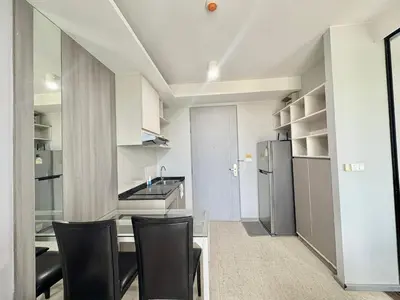 a kitchen with a table and chairs and a refrigerator at 1 Bedroom l 6th Avenue l Surin beach in Surin Beach