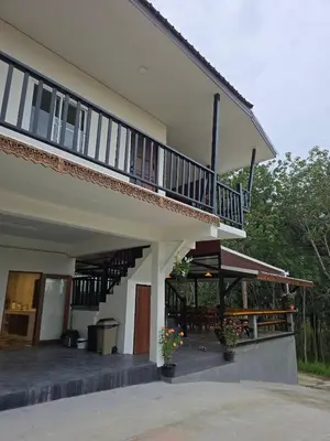 a building with a balcony and a patio at The Simple Place - King in Klong Muang Beach
