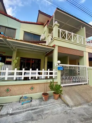 a house with a white fence in front of it at Kata Beach Townhouse 3 in Kata Beach