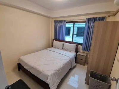 a small bedroom with a bed and a window at Kata Beach Townhouse 3 in Kata Beach