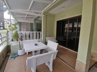 a room with a table and chairs on a balcony at Kata Beach Townhouse 3 in Kata Beach