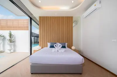 a bedroom with a bed and a large window at Wanila Villa Bangtao Beach Brand New Luxury Modern Pool Villa Laguna Phuket in Thalang