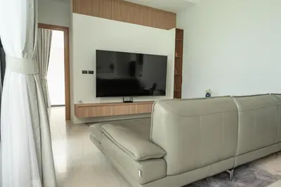 a living room with a couch and a flat screen tv at Mouana Residence Song Khun Chalong 4-bedroom Pool Villa 893 in Chalong