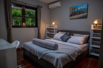 a bedroom with a large bed with a window at Ton Sai Villa - 7 bedroom pool villa - Paklok in Ban Chin Tham Mai