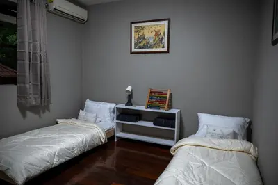 a room with two beds and a picture on the wall at Ton Sai Villa - 7 bedroom pool villa - Paklok in Ban Chin Tham Mai