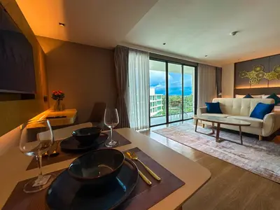 a living room with a table with wine glasses at Large Lux Studio in La Vita 5-star Rawai in Rawai Beach