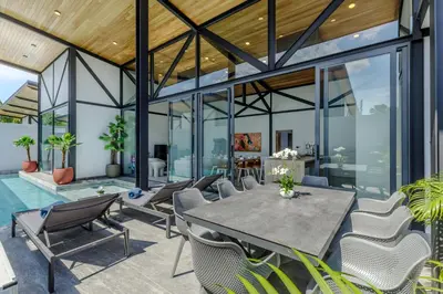 an open living room with a table and chairs at Modern 4-Bedroom Solar Villa with Pool & Game Zone at Sunset Garden 15 in Rawai Beach