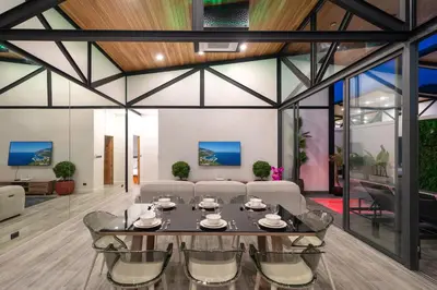 a living room with a table and chairs at Sunset Garden 16 - Eco Design Villa with Private Pool near Nai Harn Beach in Rawai Beach