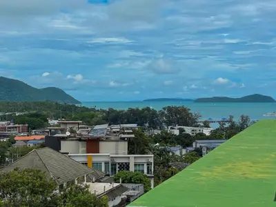 a view of a city and the ocean at Luxury 5-star Duplex in La Vita Sea View in Rawai Beach