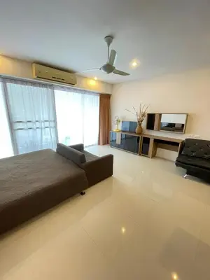 a bedroom with a bed and a couch and a tv at Karon Chic Seashore Apartment in Karon Beach