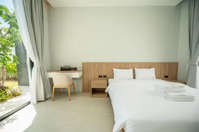 a bedroom with a white bed and a window at Mouana Residence Song Khun Chalong 4-bedroom Pool Villa 896 in Chalong