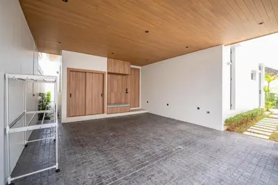 an empty living room with a wooden ceiling at Mouana Residence Song Khun Chalong 4-bedroom Pool Villa 896 in Chalong