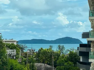 a view of the water from a building at La Vita Rawai Nai Harn Beach 5 Star 1 BDR in Rawai Beach