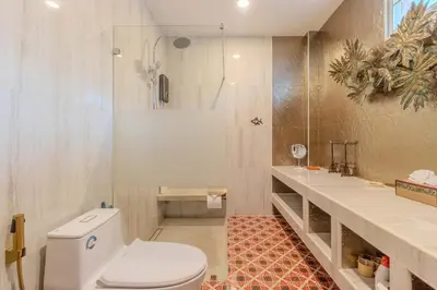 a bathroom with a toilet and a shower at V225 Spacious 3BR Villa Pool and Garden Near Beach in Rawai Beach