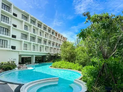 a swimming pool in front of a building at New Modern 1Bdr Laya 500 m to the Beach in Layan Beach