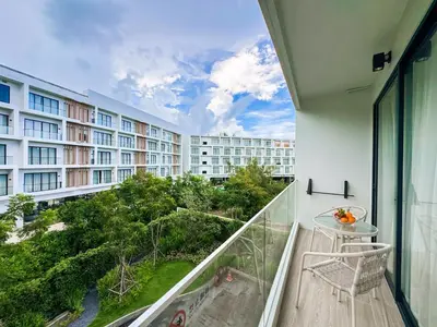 a balcony with a table and a view of a building at New Modern 1Bdr Laya 500 m to the Beach in Layan Beach